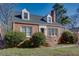 Quaint brick home with a gray roof, dormer windows, and manicured shrubbery enhancing its curb appeal at 469 Mellview Sw Ave, Atlanta, GA 30310