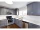 Updated kitchen featuring gray cabinetry, white countertops, and stainless-steel appliances at 469 Mellview Sw Ave, Atlanta, GA 30310