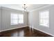 Bright living room with hardwood floors, fresh paint, and lots of natural light from two large windows at 469 Mellview Sw Ave, Atlanta, GA 30310