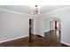 Open concept living room with stylish light fixture, hardwood floors, and neutral color palette at 469 Mellview Sw Ave, Atlanta, GA 30310