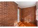 This sunroom has brick walls, tile flooring, and windows at 469 Mellview Sw Ave, Atlanta, GA 30310