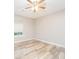 Cozy bedroom featuring a ceiling fan, neutral walls, and a window overlooking the yard at 5354 Cherry Wood Drive Dr, Stone Mountain, GA 30083