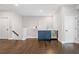 Finished basement featuring a wet bar with blue cabinetry, stainless mini fridge, and wood floors at 2111 Bellrick Nw Rd, Atlanta, GA 30318