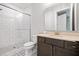 Bathroom with tiled shower, glass door, and modern vanity at 2111 Bellrick Nw Rd, Atlanta, GA 30318