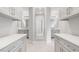 Bright bathroom featuring dual vanities, a full-length mirror, and gray cabinets at 2111 Bellrick Nw Rd, Atlanta, GA 30318