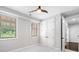 Neutral bedroom featuring large windows, ceiling fan and closet at 2111 Bellrick Nw Rd, Atlanta, GA 30318