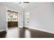 Bright bedroom boasts dark hardwood floors, neutral walls, balcony access, and natural light at 2111 Bellrick Nw Rd, Atlanta, GA 30318