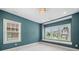 Bedroom with teal walls and a window seat featuring multiple windows at 2111 Bellrick Nw Rd, Atlanta, GA 30318