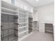 Open closet with shelves, metal baskets, drawers and a desk area at 2111 Bellrick Nw Rd, Atlanta, GA 30318