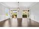 Dining room with French doors opening to a covered balcony and neighborhood views at 2111 Bellrick Nw Rd, Atlanta, GA 30318