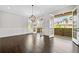 Bright dining room with dark hardwood floors and French doors opening to a covered balcony at 2111 Bellrick Nw Rd, Atlanta, GA 30318
