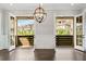 Dining room with French doors opening to a covered balcony and neighborhood views at 2111 Bellrick Nw Rd, Atlanta, GA 30318