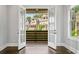 Dining room with French doors opening to a covered balcony and neighborhood views at 2111 Bellrick Nw Rd, Atlanta, GA 30318