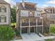 Stunning three-story home with a brick exterior, balconies, and a two-car garage at 2111 Bellrick Nw Rd, Atlanta, GA 30318
