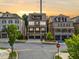 Beautiful street view of a three-story brick home with inviting balconies at sunset at 2111 Bellrick Nw Rd, Atlanta, GA 30318