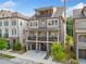 Inviting three-story brick home featuring a two-car garage and multiple balconies at 2111 Bellrick Nw Rd, Atlanta, GA 30318