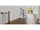 Hallway with black wrought iron stair rail, hardwood floors, and a view to the exterior balcony at 2111 Bellrick Nw Rd, Atlanta, GA 30318