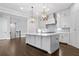 Bright kitchen features a large center island with stone countertop and pendant lights at 2111 Bellrick Nw Rd, Atlanta, GA 30318