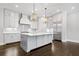 Bright kitchen features a large center island with stone countertop and pendant lights, plus stainless steel appliances at 2111 Bellrick Nw Rd, Atlanta, GA 30318