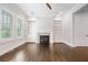 Spacious living room featuring a fireplace with custom built-in shelving and cabinetry at 2111 Bellrick Nw Rd, Atlanta, GA 30318
