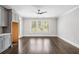 Open-concept living room featuring a kitchen with stainless steel appliances and hardwood floors at 2111 Bellrick Nw Rd, Atlanta, GA 30318