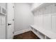Mudroom features a built in bench with storage and hooks, as well as a door to the garage at 2111 Bellrick Nw Rd, Atlanta, GA 30318