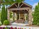 Stone pavilion with fireplace, ceiling fan, and outdoor seating at 2111 Bellrick Nw Rd, Atlanta, GA 30318