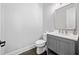 Powder room featuring modern gray vanity, granite countertop, toilet, and dark hardwood floors at 2111 Bellrick Nw Rd, Atlanta, GA 30318