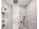 Shower boasts dual shower heads, marble-look tiling, and glass door entry at 2111 Bellrick Nw Rd, Atlanta, GA 30318