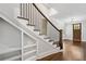 Elegant staircase with dark wood railings and white risers leading to an open-concept living area at 2111 Bellrick Nw Rd, Atlanta, GA 30318