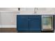Stylish wet bar with blue cabinetry, a stainless steel beverage cooler, and white countertops at 2111 Bellrick Nw Rd, Atlanta, GA 30318