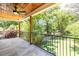 A covered porch with a ceiling fan overlooks a fenced-in yard with mature trees at 2808 Hosea L Williams Dr, Atlanta, GA 30317