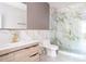 Modern bathroom with marble shower, toilet, and vanity with wooden cabinets and gold fixtures at 2808 Hosea L Williams Dr, Atlanta, GA 30317