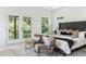 Bright bedroom with double doors leading to a balcony, complemented by a comfortable seating area at 2808 Hosea L Williams Dr, Atlanta, GA 30317
