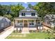 Charming two-story home featuring a brick porch, wood pillars, and a well-manicured lawn at 2808 Hosea L Williams Dr, Atlanta, GA 30317