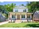 Charming two-story home featuring a brick porch, wood pillars, and well-manicured lawn at 2808 Hosea L Williams Dr, Atlanta, GA 30317