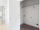 Bright laundry room features a functional layout with a white storage shelf, white walls and gray tile floors at 2808 Hosea L Williams Dr, Atlanta, GA 30317