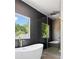 Modern shower features black, textured tile, a glass door, gold fixtures, and a rainfall shower head at 2808 Hosea L Williams Dr, Atlanta, GA 30317