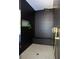 Modern shower features black, textured tile, a rainfall shower head, and a bench at 2808 Hosea L Williams Dr, Atlanta, GA 30317