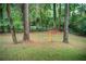 A backyard play gym hanging between mature trees at 3076 Montheath Pass, Duluth, GA 30096