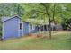 Backyard view of home with mature trees and swing hanging from tree at 3076 Montheath Pass, Duluth, GA 30096