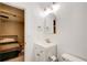 Bright bathroom featuring a vanity, gold fixtures, and direct access to the bedroom at 3076 Montheath Pass, Duluth, GA 30096