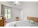 Bright bedroom with a plush bed, carpet flooring, and a large window with natural light at 3076 Montheath Pass, Duluth, GA 30096