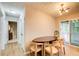 Bright dining room with modern lighting, hardwood floors, and access to outdoor patio at 3076 Montheath Pass, Duluth, GA 30096