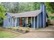 Charming blue house with covered porch and well-manicured landscaping at 3076 Montheath Pass, Duluth, GA 30096
