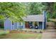 Charming home featuring a landscaped front yard, inviting entryway, and quaint front porch at 3076 Montheath Pass, Duluth, GA 30096