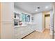 Bright white kitchen with stylish fixtures and floating shelves at 3076 Montheath Pass, Duluth, GA 30096