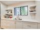 Bright kitchen with white cabinets, quartz countertops, stainless steel sink, and backyard view at 3076 Montheath Pass, Duluth, GA 30096