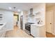 Modern white kitchen with stainless steel appliances and ample storage at 3076 Montheath Pass, Duluth, GA 30096