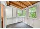 Cozy sunroom with natural light, carpet flooring and views of the wooded backyard at 3076 Montheath Pass, Duluth, GA 30096